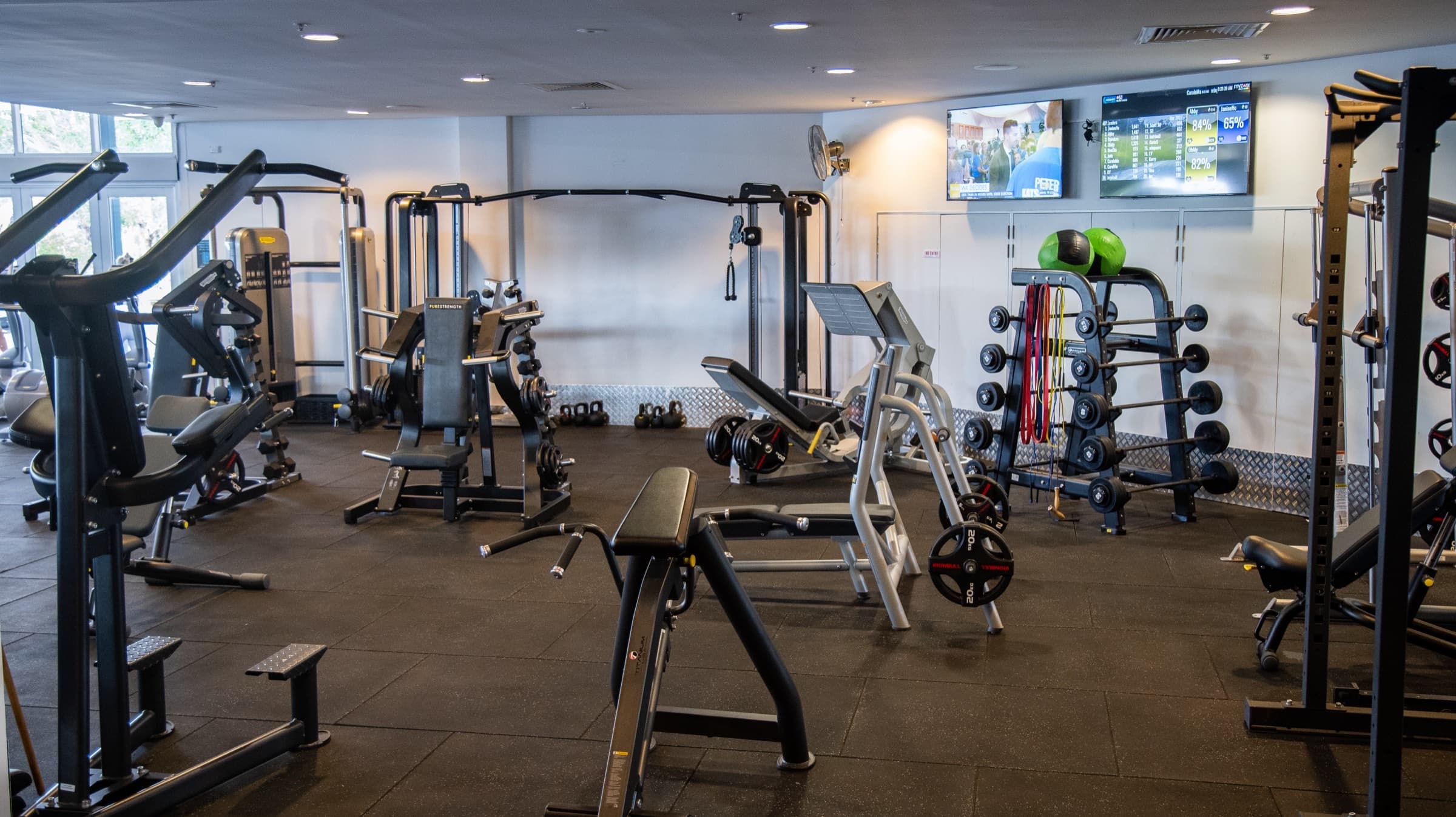Strength floor with pin-loaded machines and squat racks